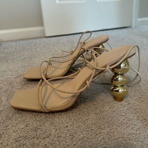 Tan high heels with gold heel